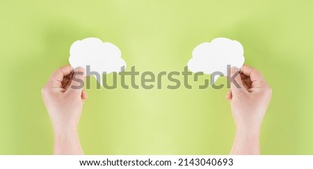 Holding a white cloud in the hand, empty copy space for text, pink background, communication and marketing concept, being connected, networking
