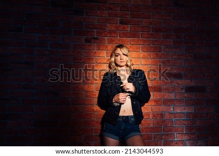beautiful woman blonde portrait against the kirpist wall