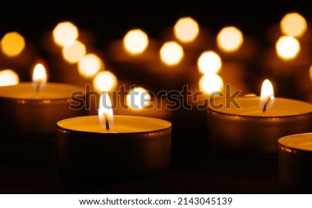 Many burning candles with bokeh light background Royalty-Free Stock Photo #2143045139