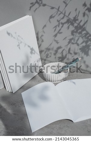 Blank pages, book cover mock ups,  template on gray  background with leaf shadow.
