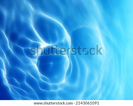 Blur​ abstract​ of​ surface​ blue​ water. Abstract​ of​ surface​ blue​ water​ reflected​ with​ sunlight​ for​ background.Top​ view​ of blue​ water.​ Water​ splashed​ use​ for​ graphic​ design.
