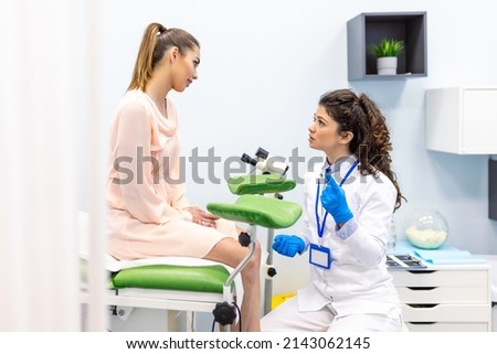 A gynecologist is examined by a patient who is sitting in a gynecological chair. Examination by a gynecologist. Female health concept. Royalty-Free Stock Photo #2143062145