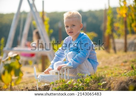 Kids having fun with toy airplane in field against nature background. Adventure and vacations children concept. Summer at countryside. Dreams of flight. Summer at countryside.