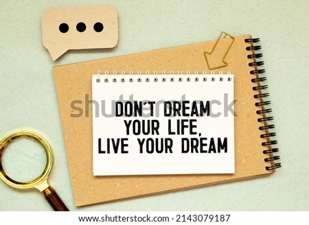 text Dont dream your life, live your dream on white paper