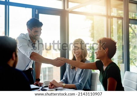 Welcome to our panel. Shot of a happy businessman welcoming his new colleague to the team during a meeting in the boardroom. Royalty-Free Stock Photo #2143110907