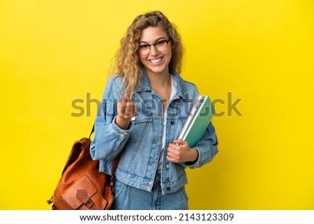 Young student caucasian woman isolated on yellow background making money gesture