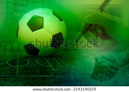Football with football player hand to sign contract , soccer transfer player, sport news reporter, business in football club Royalty-Free Stock Photo #2143140259