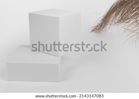 white boxes on a white background with natural grass