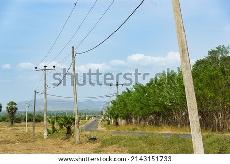 Rural road with powerlines, eastern Sri Lanka Royalty-Free Stock Photo #2143151733