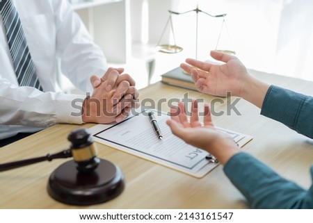 Law consultancy concept A male client explaining some confusing detail of the contract to the prosecutor  Royalty-Free Stock Photo #2143161547