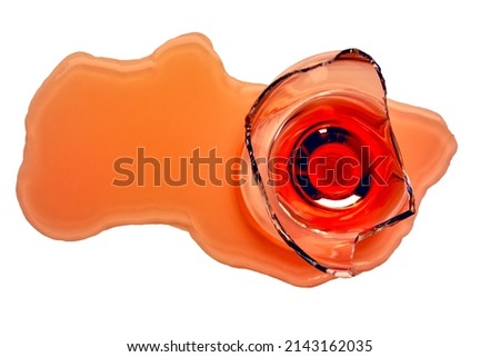 Broken wine glass stands on the table, close-up. Spilled red wine on the table, top view, isolated. Unlucky day . Royalty-Free Stock Photo #2143162035