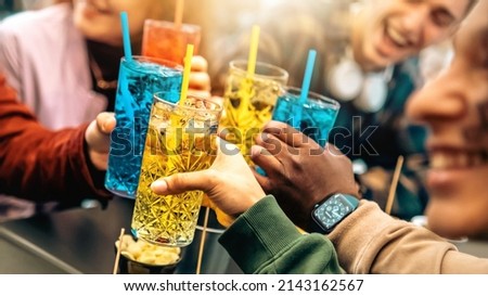 Group of friends cheering drinks glasses together - Young people enjoying happy hour at cocktail open bar - Beverage lifestyle concept Royalty-Free Stock Photo #2143162567