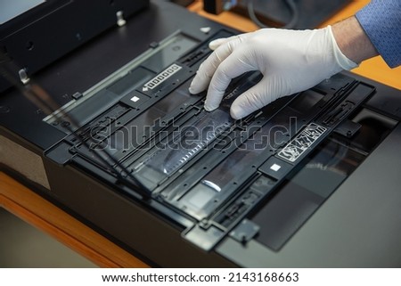 Digitization scanning of photographic film negatives on the scanner. Converting an image to digital form. Royalty-Free Stock Photo #2143168663