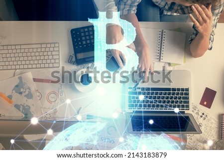 Double exposure of man and woman working together and crypto theme hologram drawing. Computer background. Blockchain concept. Top View.