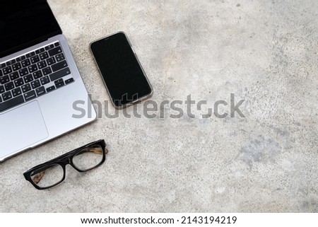 Work from home stylish table desk. Workspace with laptop, glasses and mobile phone.