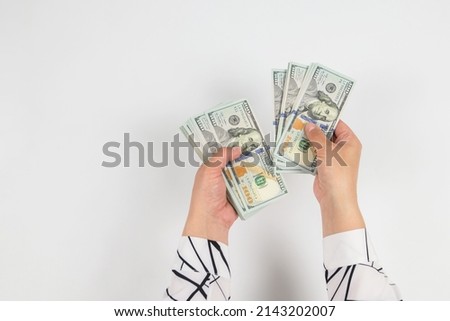 top view of dollars in female hands isolated on white.