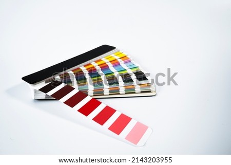 Pantone color palette guide on white background. Close-Up Of Color Sample Against White Background.
