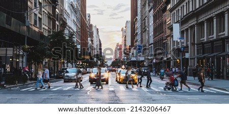 Busy street scene with crowds of people walking across an intersection on Fifth Avenue in New York City NYC Royalty-Free Stock Photo #2143206467
