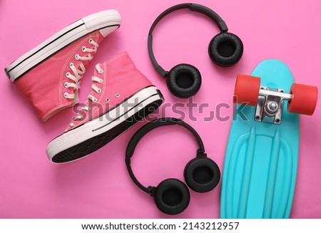 Youth hipster outfit on pink background. Flat lay. Top view