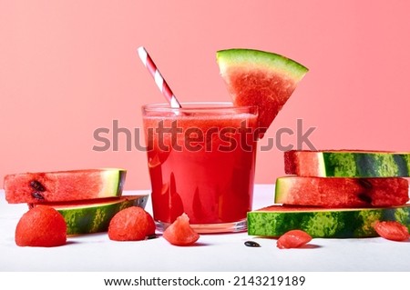 Close-up fresh watermelon juice or smoothie in glasses with watermelon pieces on pink background. Refreshing summer drink Royalty-Free Stock Photo #2143219189