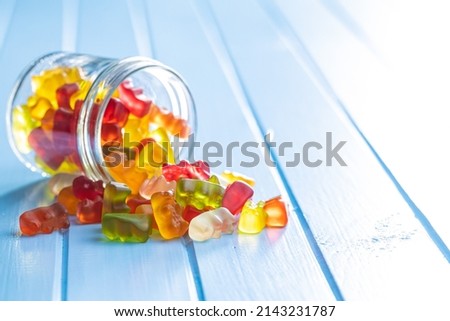 Jelly gummy bears candy. Colorful sweet confectionery on blue table. Royalty-Free Stock Photo #2143231787