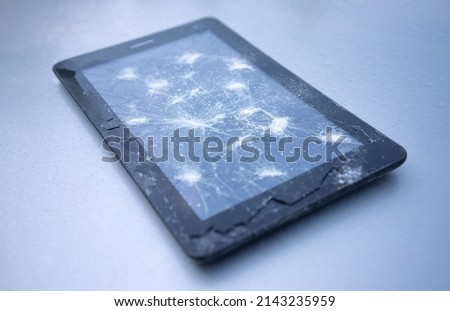 An electronic tablet with a broken touch screen. Replacing the glass on the phone. Repair of electronic equipment.