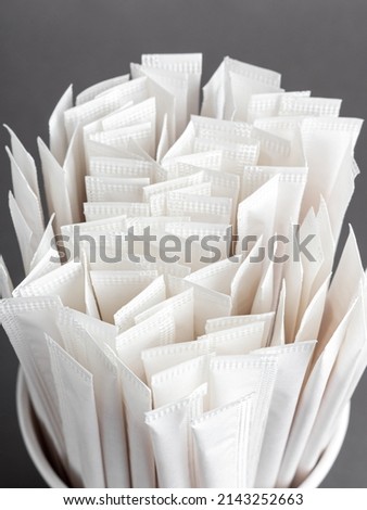 Disposable coffee stirrers in paper packaging. Wooden sticks for sugar Royalty-Free Stock Photo #2143252663