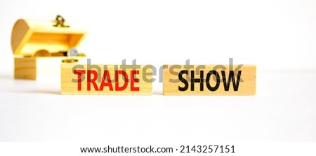 Trade show symbol. Wooden blocks with concept words Trade show on beautiful white background. Wooden chest with coins. Business economic financial trade show concept. Copy space.