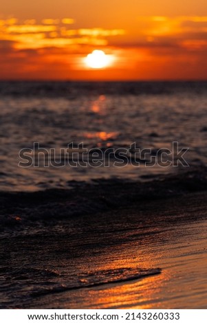 Beautiful view of the sea and the sky in the clouds at sunset. Orange red dawn, dusk on the sea coast. High quality photo