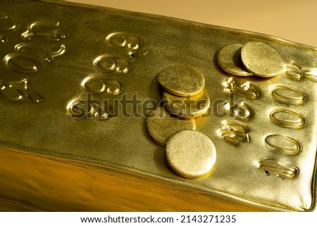 Cake in the shape of a gold bar on yellow background. Theme party concept. High quality photo