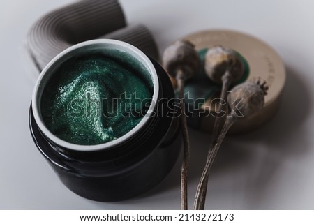 body scrub in a black jar with decor
