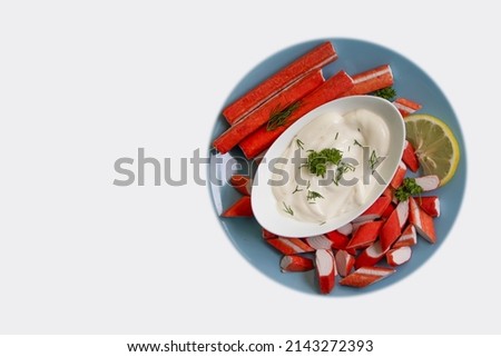 crab sticks, sauce in a plate isolated on white background