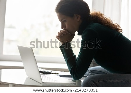 Financial problem. Thoughtful hispanic woman sit by home laptop lean on clasped hands consider on tax loan credit debt. Upset young lady freelancer understand her small business is close to bankruptcy Royalty-Free Stock Photo #2143273351