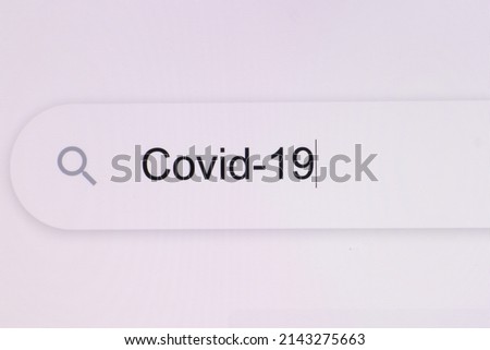 Close Up of typing COVID-19 into search bar on computer monitor. Virus or pandemic concept. How to, internet tips. Pixel art. Typing the word COVID 19 in the browser on pixelated computer screen.