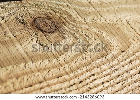 The texture of a pine board with a knot in the middle, after mechanical processing. Background image.