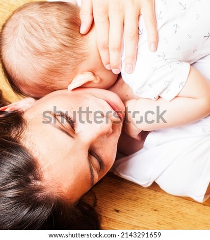 young brunette happy mother holding toddler baby son, breast-feeding concept, people lifestyle
