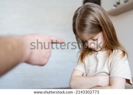 Violence against children. Father scolds and threaten her child girl. family relationships. Discipline, yelling, spanking concept. Royalty-Free Stock Photo #2143302773