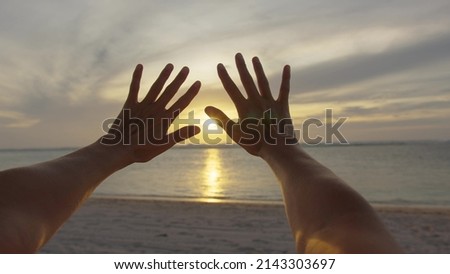 Woman stretches out her hands in the sun. Faith in god dream a religion concept. Hands in the sun close-up silhouette sunlight dream of happiness