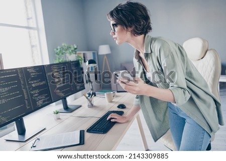 Profile side view portrait of attractive skilled focused experienced girl tech manager coding task solution at work place station indoors Royalty-Free Stock Photo #2143309885