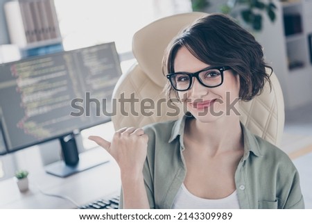 Photo of smiling server expert lady sitting chair direct thumb screen good mood workplace building inside