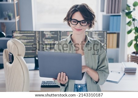 Photo of charming positive web designer hold use netbook write message daylight office indoors Royalty-Free Stock Photo #2143310187