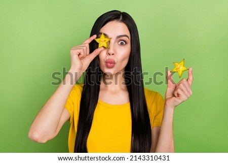 Photo of fooling impressed woman wear yellow t-shirt holding tropical fruit cover eye lips plump isolated green color background