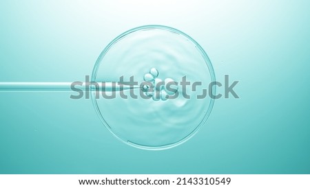 Top view shot of air bubbles coming out from lab dropper and floating on the surface of transparend liquid in petri dish on pale blue background | Abstract cosmetic ingredients formulating concept Royalty-Free Stock Photo #2143310549