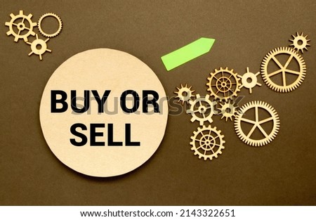 Buy or sell question on blackboard. Buying or selling question mark. Finance, economy, stock or real estate concept - time to buy or sell