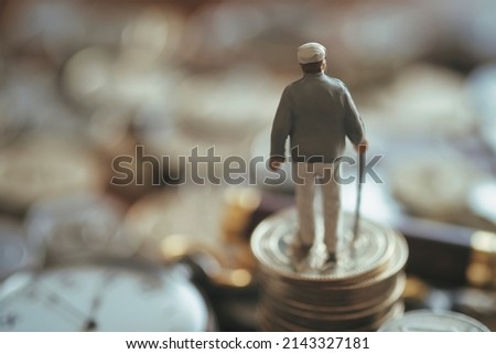 Miniature senior men and money Royalty-Free Stock Photo #2143327181