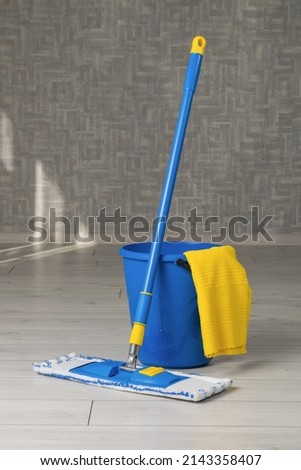 A mop, a bucket and a rag in the cleaning room. Home and office cleaning kit. The concept of maintaining cleanliness. Flat lay.