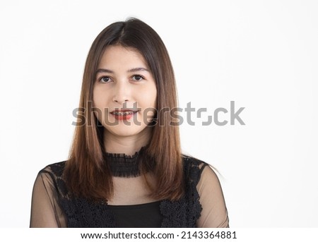 Portrait of young attractive Asian woman with brown hair wearing black revealing dress smiling with confident. Isolated.