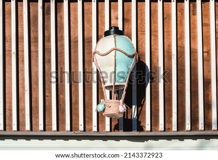 Art lantern on the background of a wooden wall.