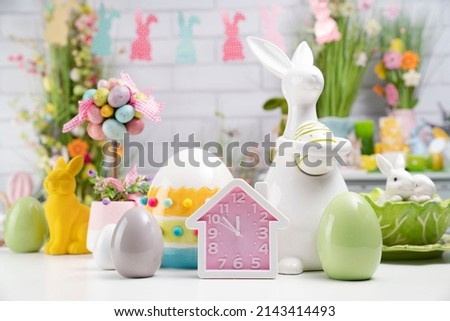 Colorful Easter decorations. White brick wall. Place for typography.