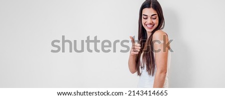 Picture of nice caucasian girl, giving thumbs up after taking her shot.